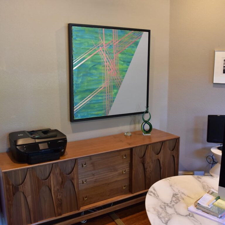 color shifting green, metallic and gray painting on display on office wall
